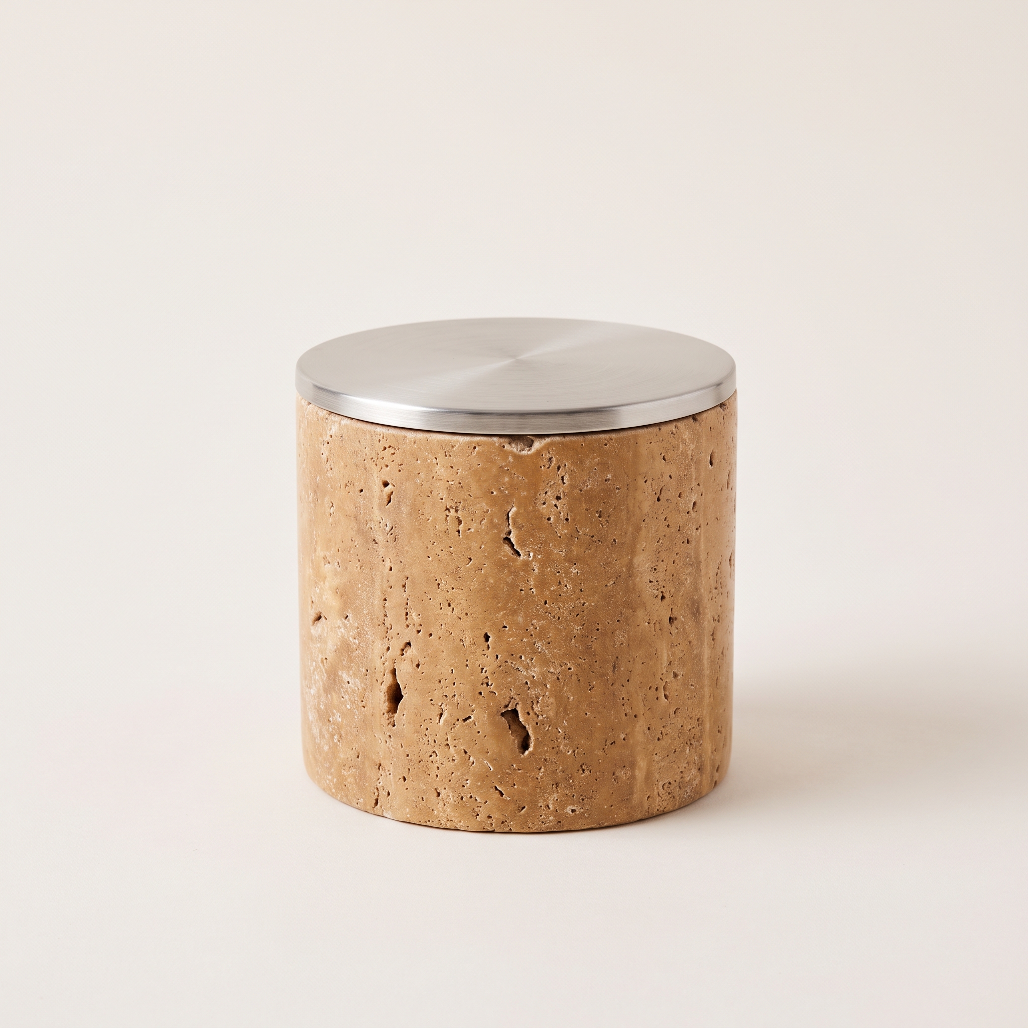 Dusk Vessel Candle, Coconut and soy wax candle in a honed travertine cylinder with a brushed steel lid, 3.5 inches wide by 4 inches tall, 9 ounces, warm sand